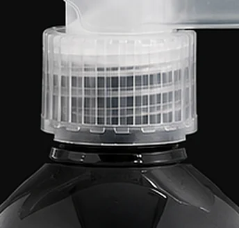 The ribbed clear collar of the WakaWax spray head above the black bottle